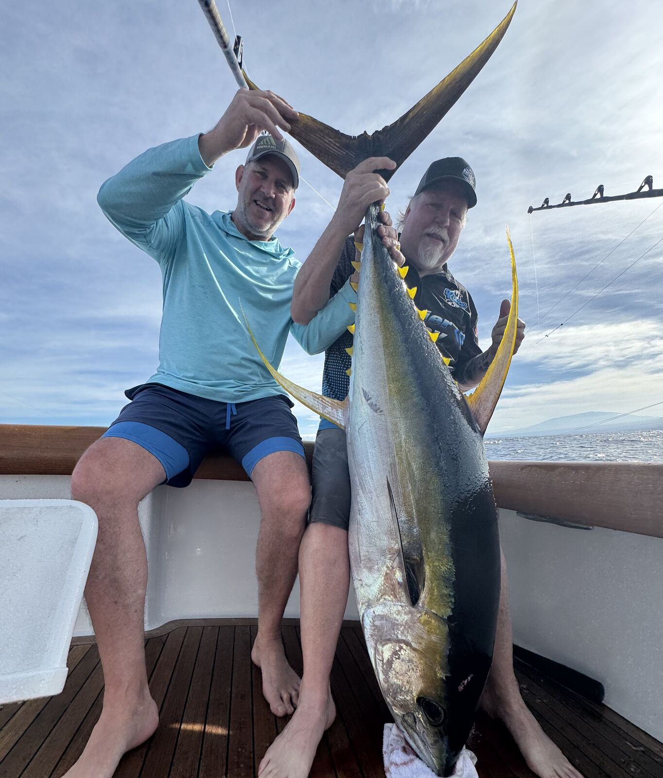 Two anglers with big yellowfin at sunrise