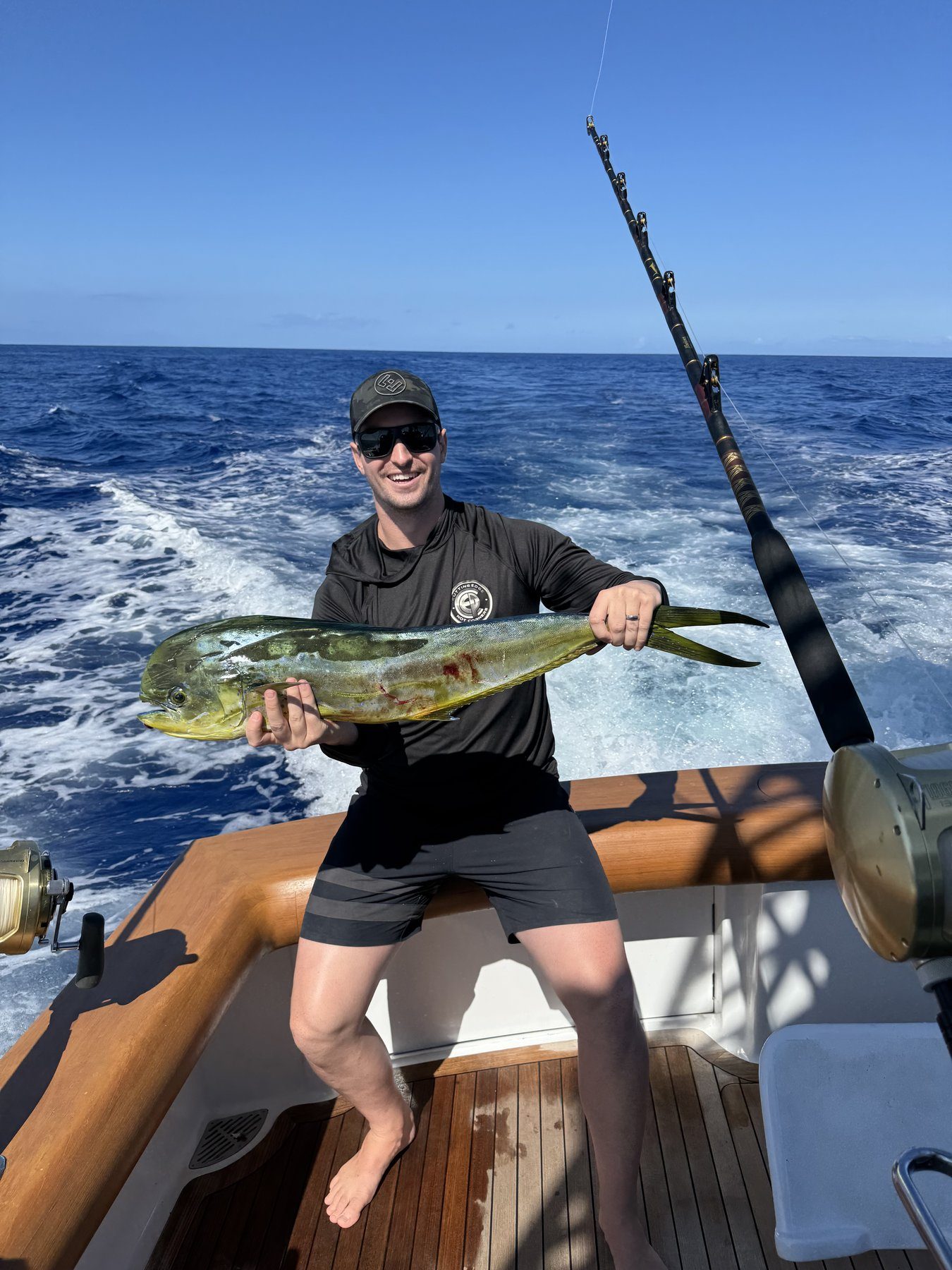 Angler with iridescent mahi mahi