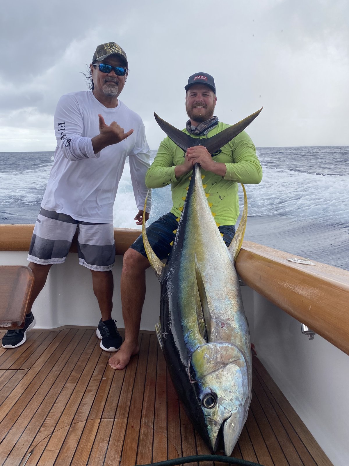 Captain and angler with a giant yellowfin ahi on the deck